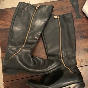 Black knee high boots. Double zipper on each.